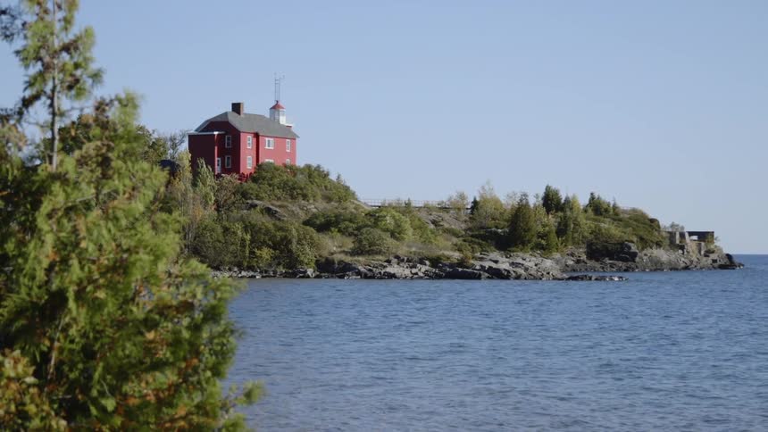Water ripples and flows by a coastal building