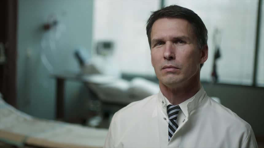 Doctor standing in an empty hospital room