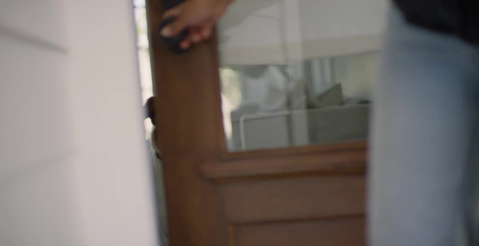Woman motions for a dog to stay and closes the door