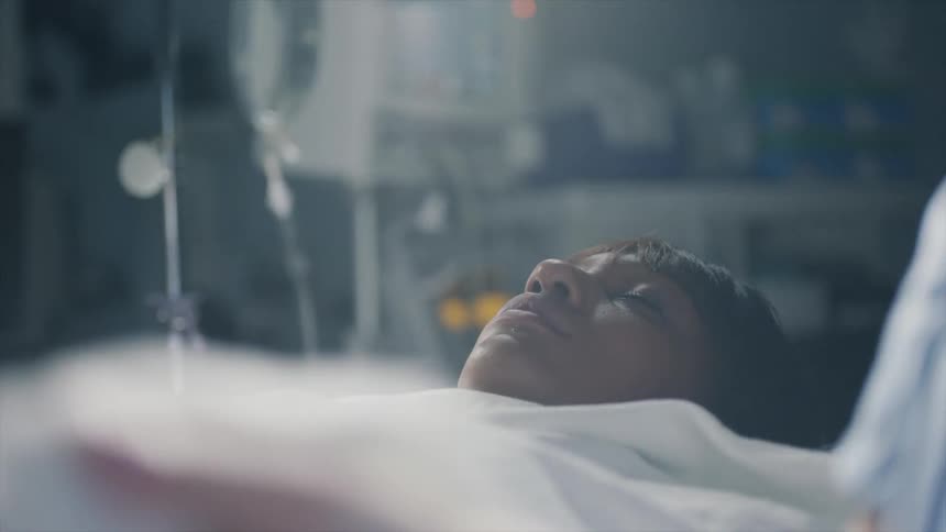 A sleeping woman with medical devices behind her