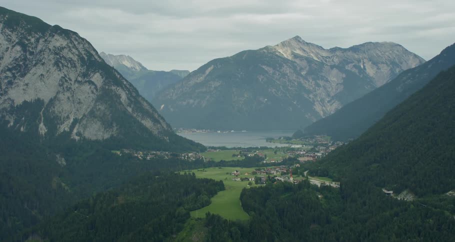 The town sits by the forest along the mountain range