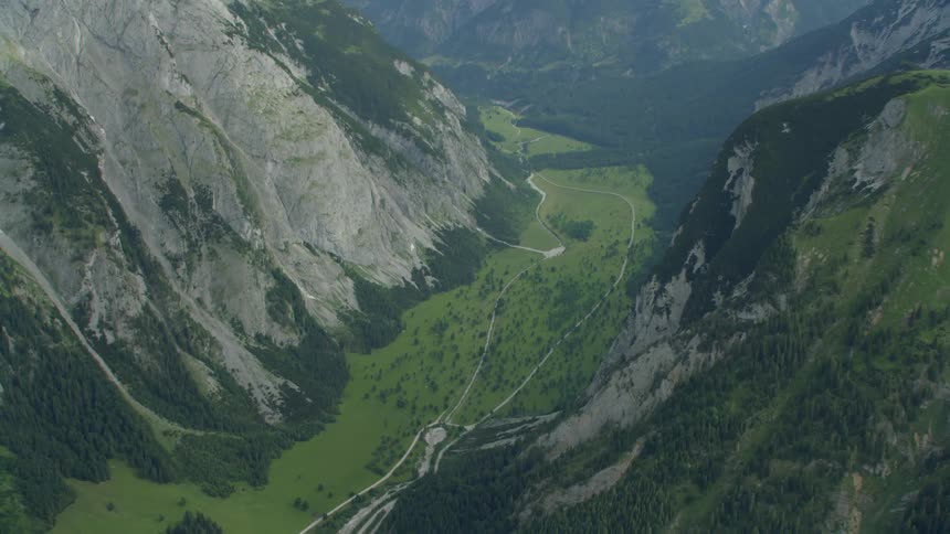 Large rocky mountain range covered with grass