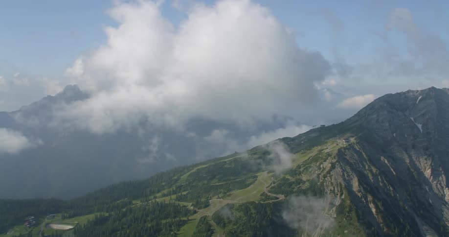 The large clouds cover the top of the mountain