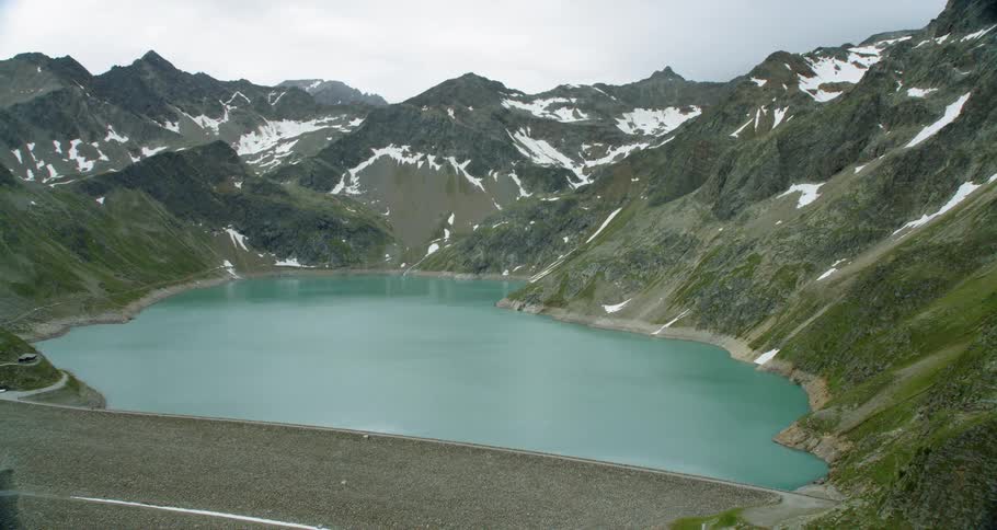 The lake is calm between the mountains
