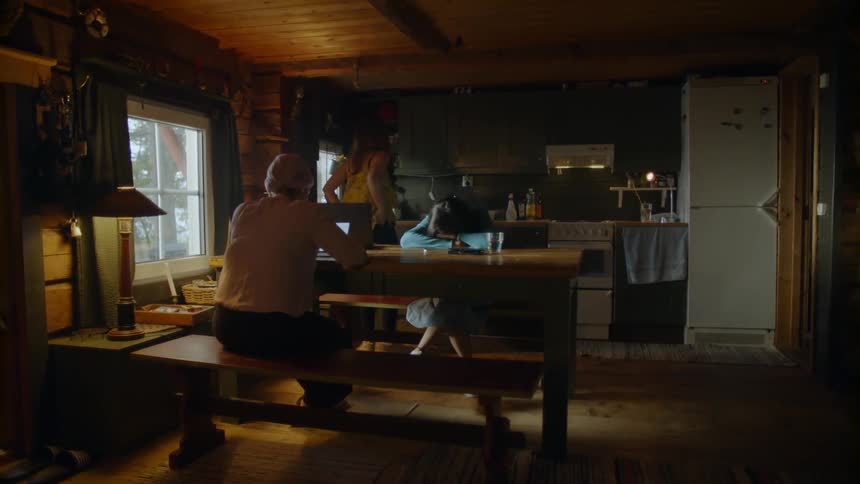 The woman paces as two women watch on at the table