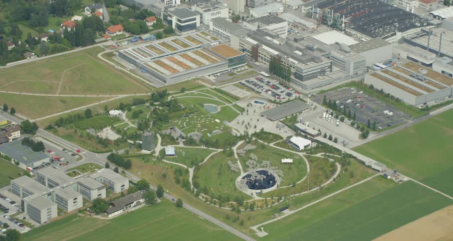 The town below has buildings and a large park