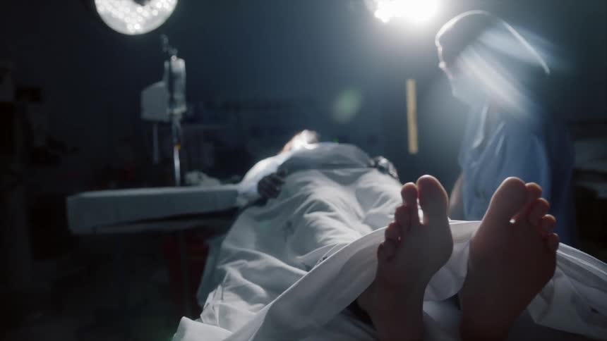 A patient lies on a hospital bed