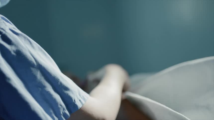 Nurse checking an oxygen monitor of female patient