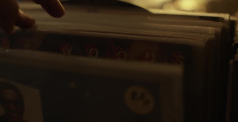 A person thumbs through some items in a display