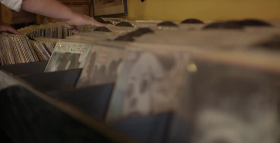 Someone is looking through a bunch of old records