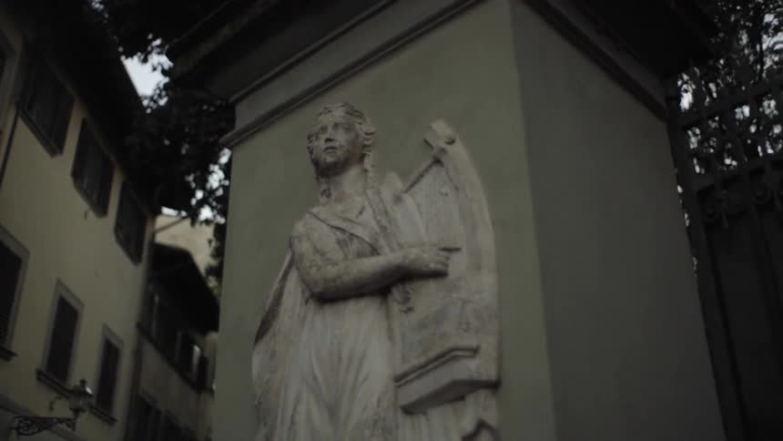 A view of a sculpture on a pillar near a building