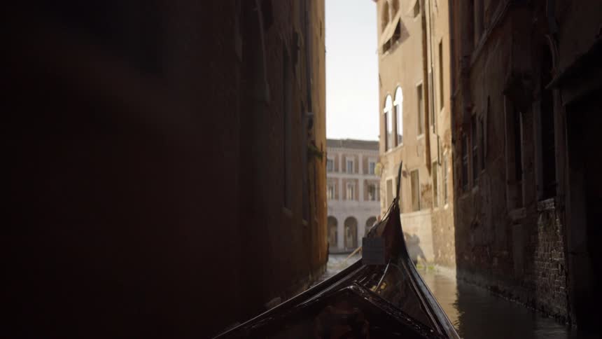 A gondola maneuvers through a canal