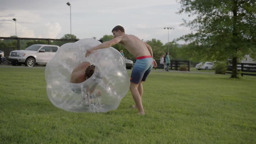 A man is charged and rolled around in a giant inflatable bubble
