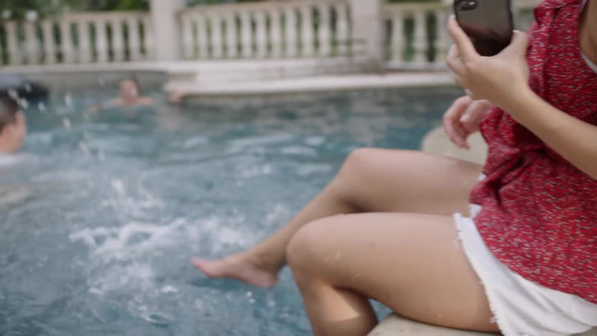 The two people in the pool get splashed