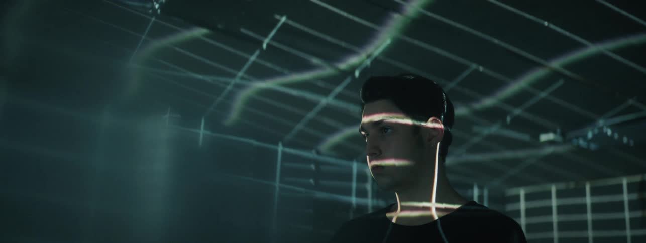 The man stands in the room with strobe lights