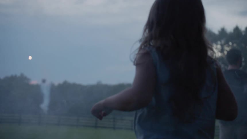 The child watches as the fireworks shoot into the sky