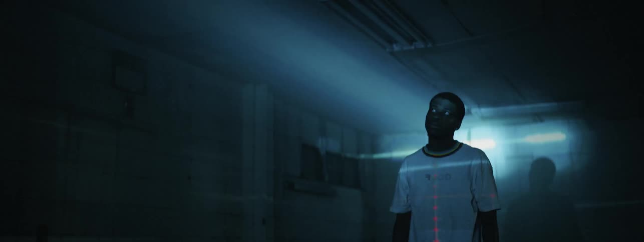The man stands in the dark room with lights flashing