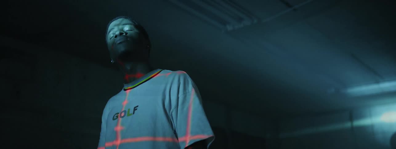 Man with laser grid on shirt stares at strobe light