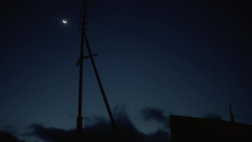 The moon is one quarter in the night sky