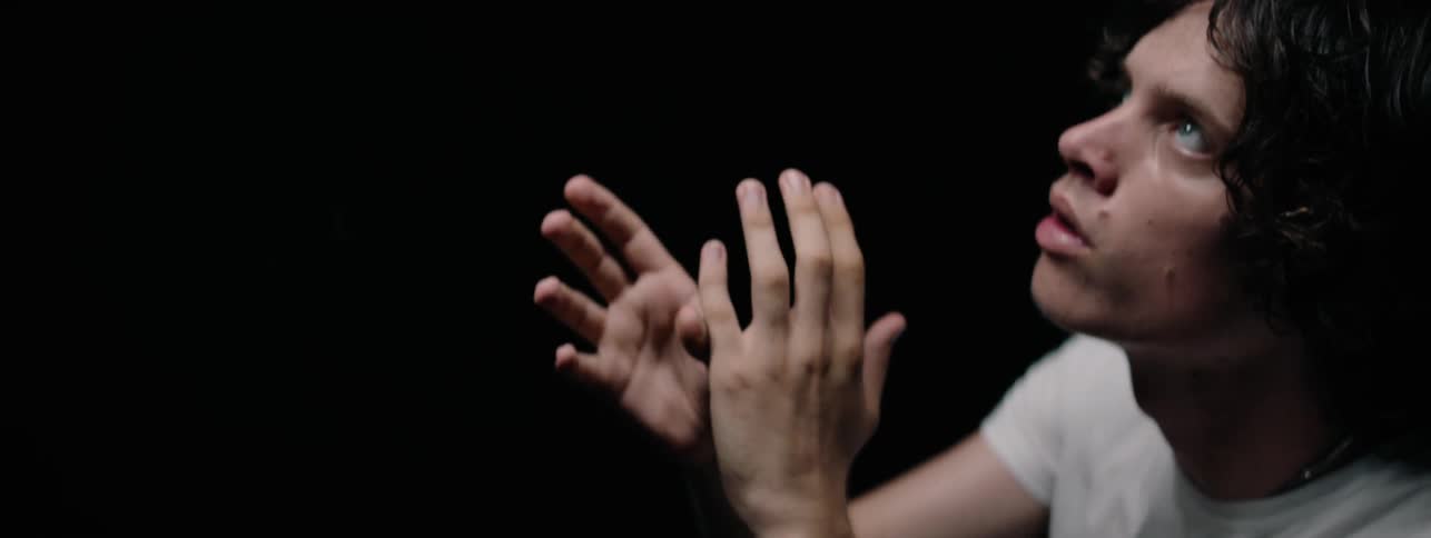 The man waves his hands around looking up at the ceiling