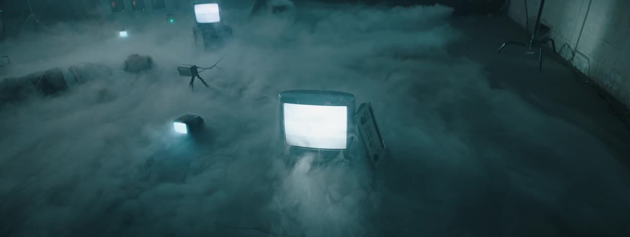 The televisions are on as the fog rolls over them
