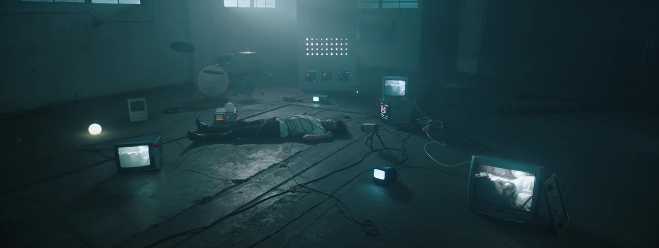 The man is covered in wires on the ground