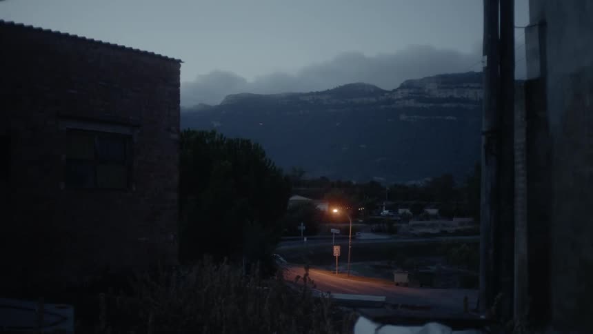 Single light illuminates the dark near the mountains