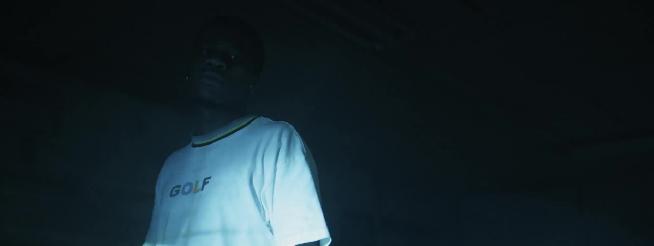 The man looks to his side as the lights flash on him