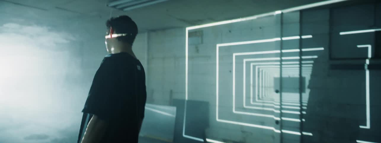 Man turns around in a room as rectangular lights illuminate