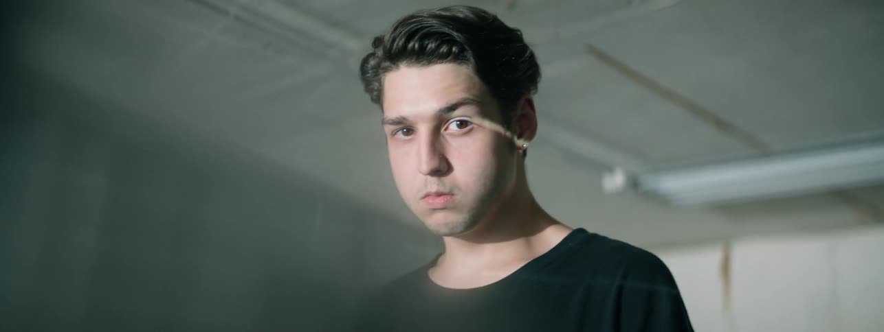 The man looks to the side in the room