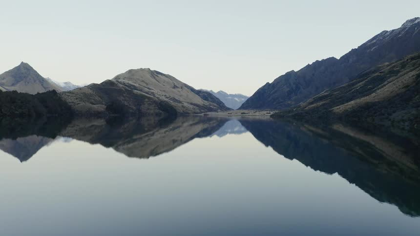 The lake is calm and reflective near the mountains