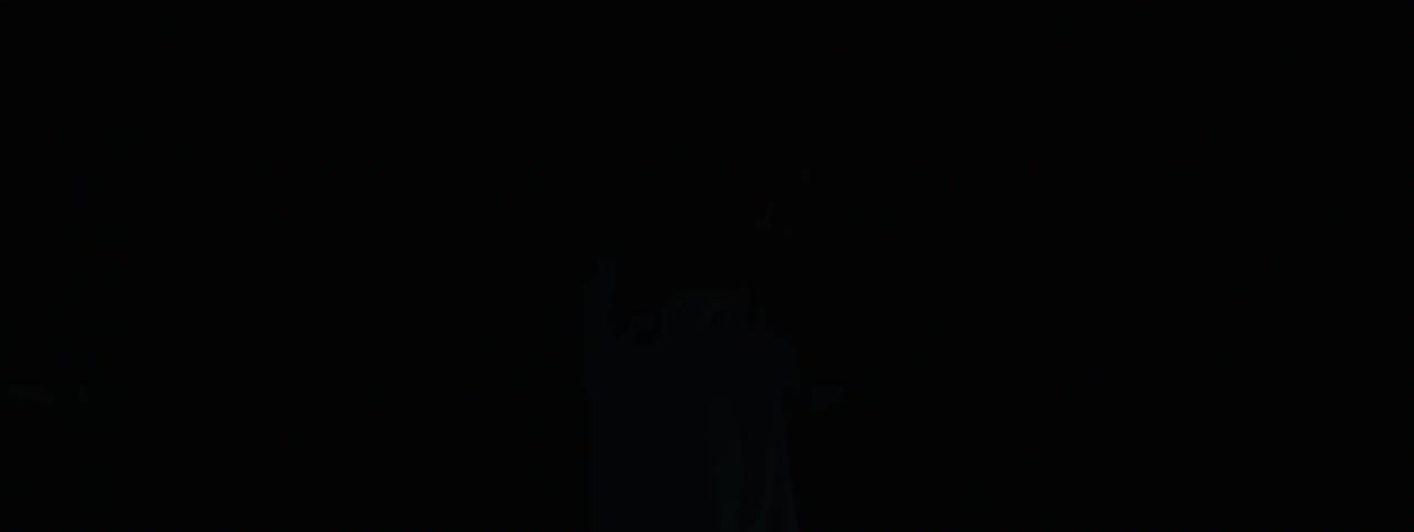 The man shields his eyes from the blinking lights