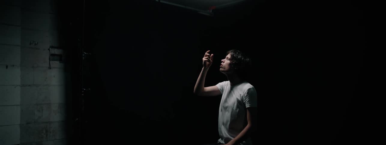 Man raises hand to ceiling then lowers it