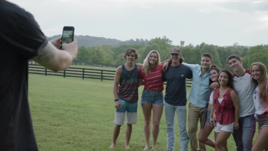 The people are gathered together as a photo is taken