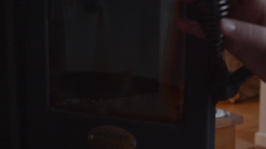 A person opens the iron oven