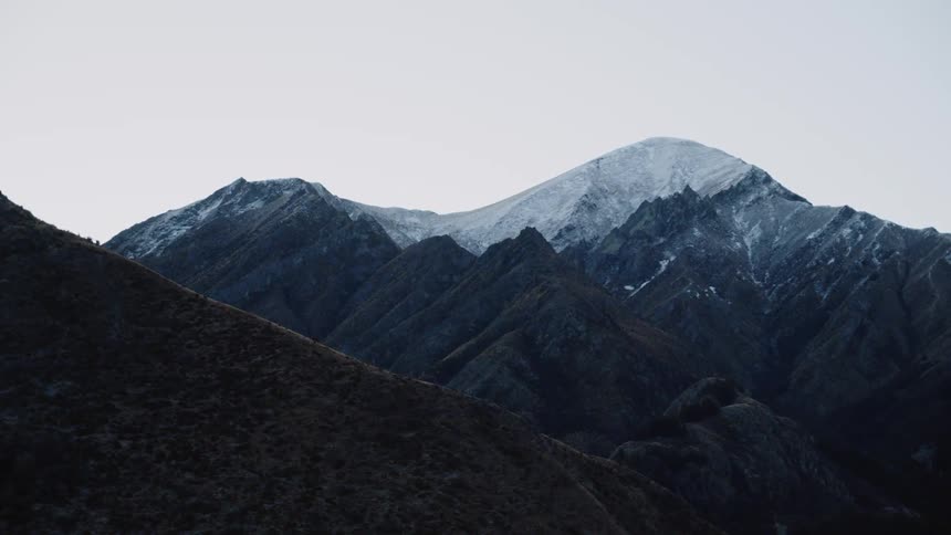 A mountain range on a gray foggy day