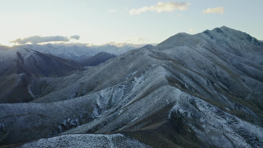 The mountain range is covered with a dusting of snow