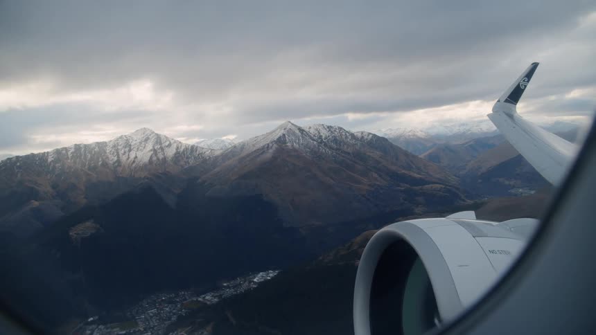 Airplane hovers low over mountains