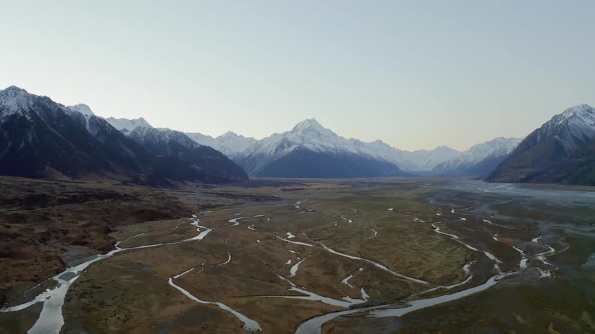 Many streams are flowing through a mountain valley in daylight