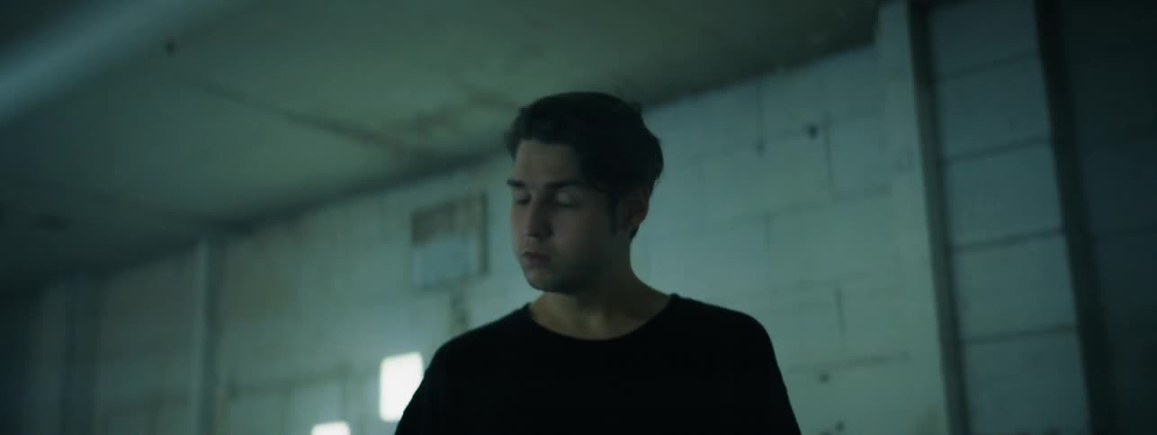 The man looks around in the room with flashing lights