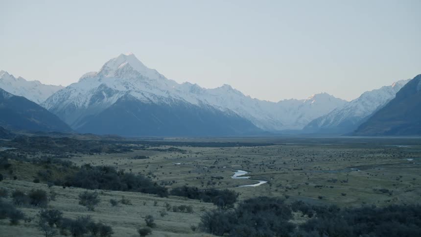 Shrubbery on a large field with large mountains