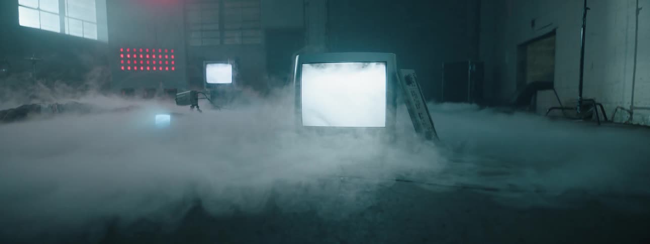 Man on a monitor screen appears in the white mist