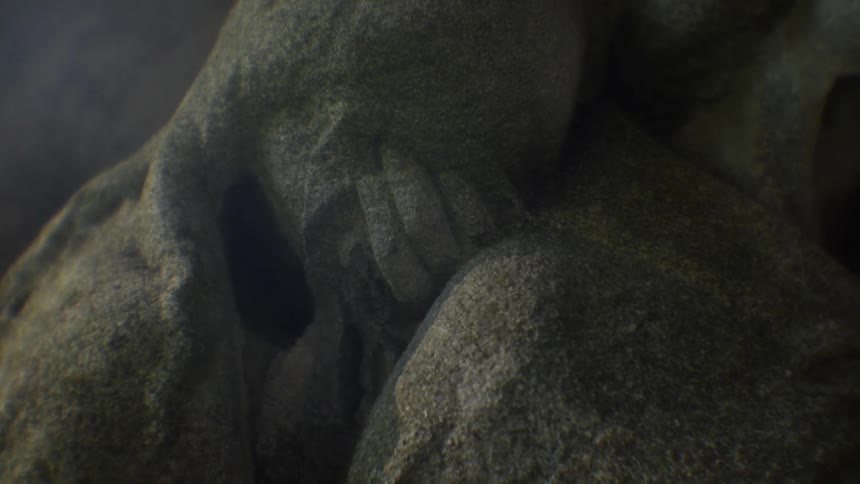The statue is of a person covering their face