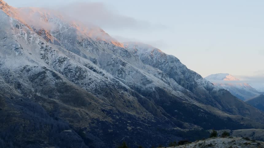 The mountain is covered with snow halfway up