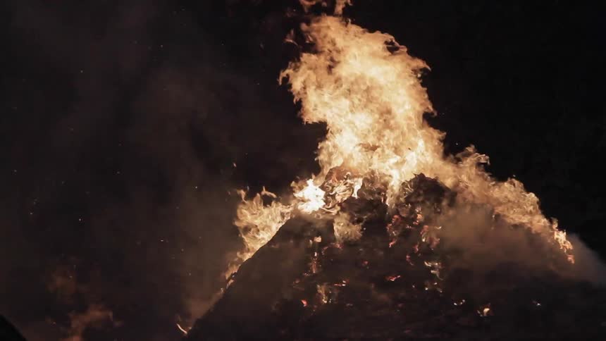 A fire is raging on a dark night