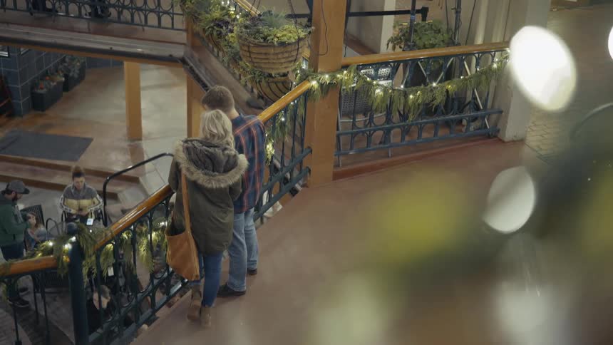 Woman and man are glancing down in a store