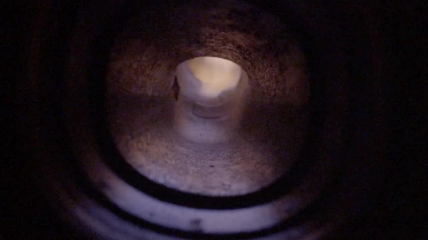 Flames shooting down through a flue pipe