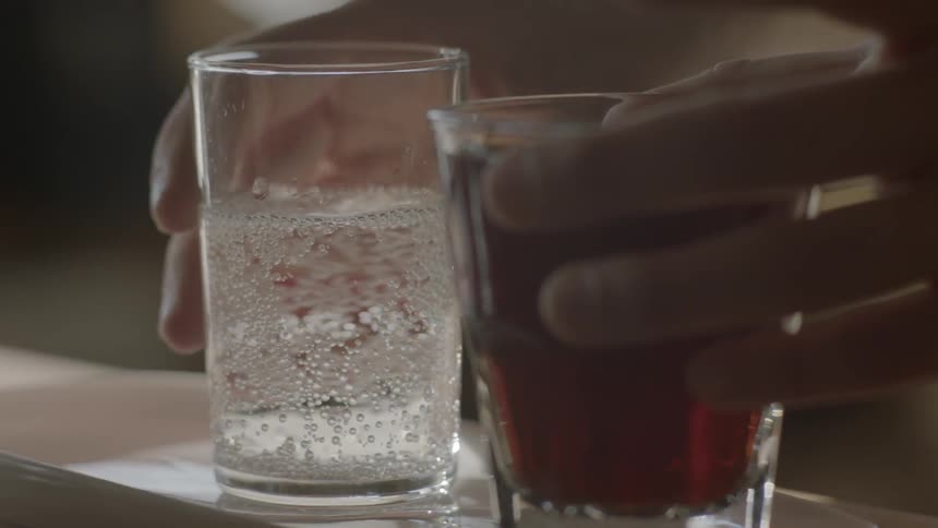 A beverage is placed next to a carbonated drink