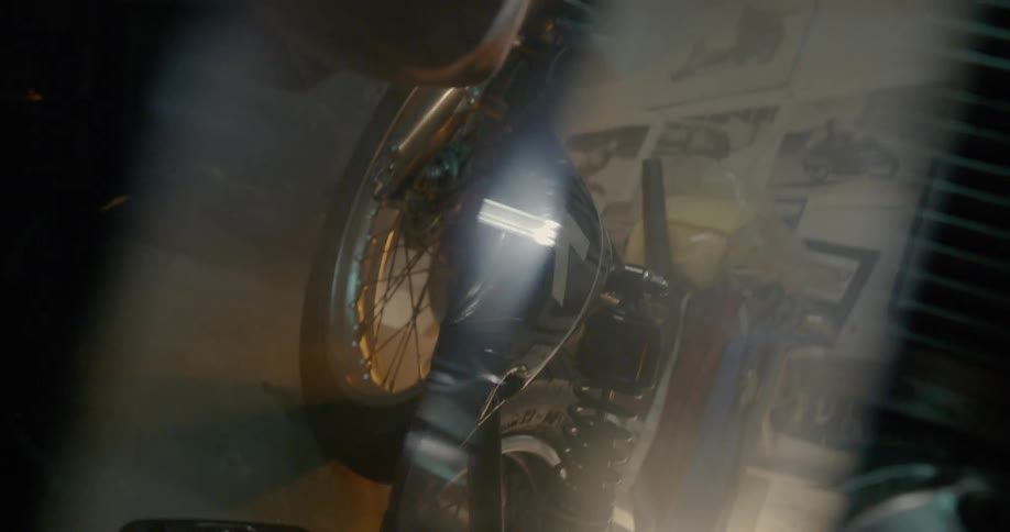 Man Working On Motorcycle In Garage