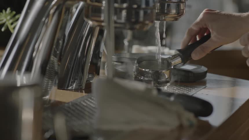 A professional serving tool is being rinsed off under hot water